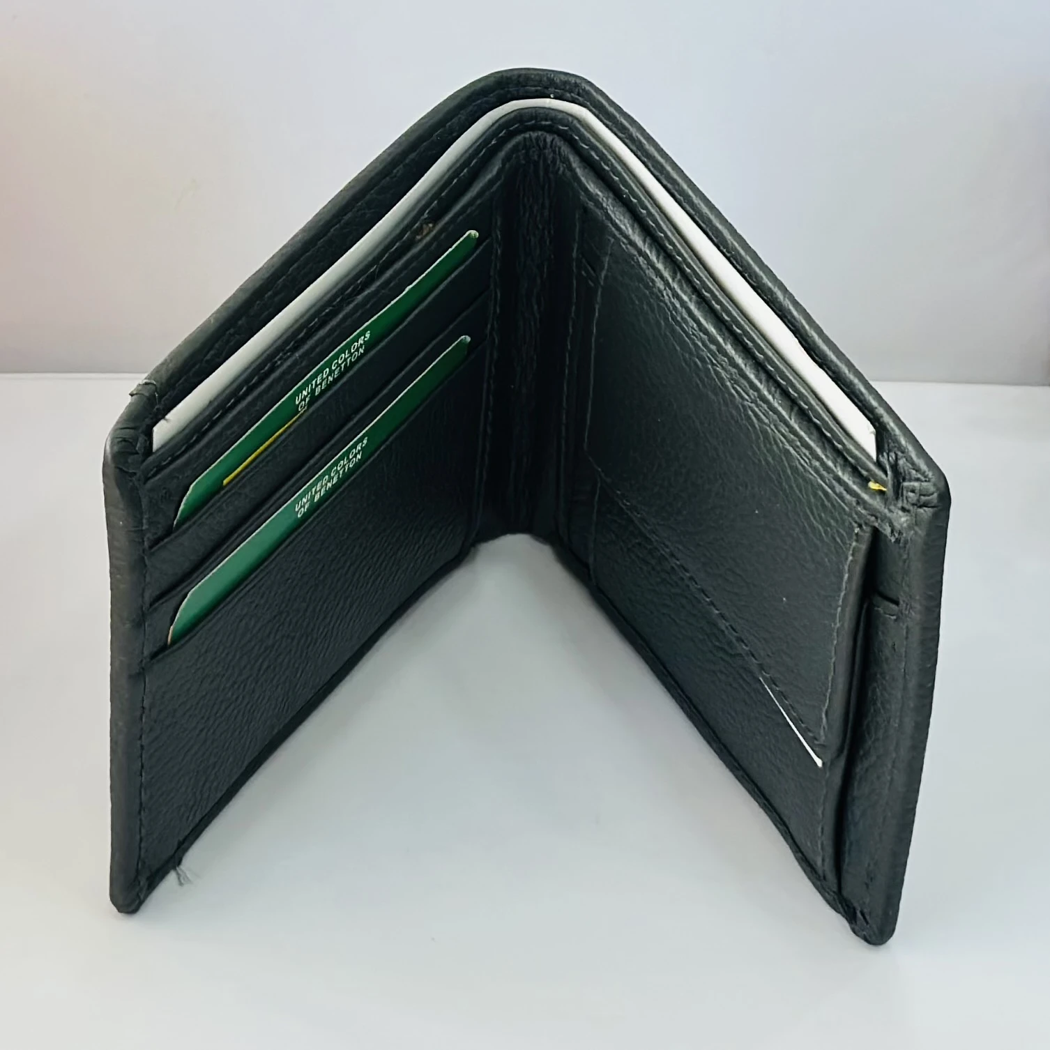 Black leather bi-fold wallet from United Colors of Benetton.