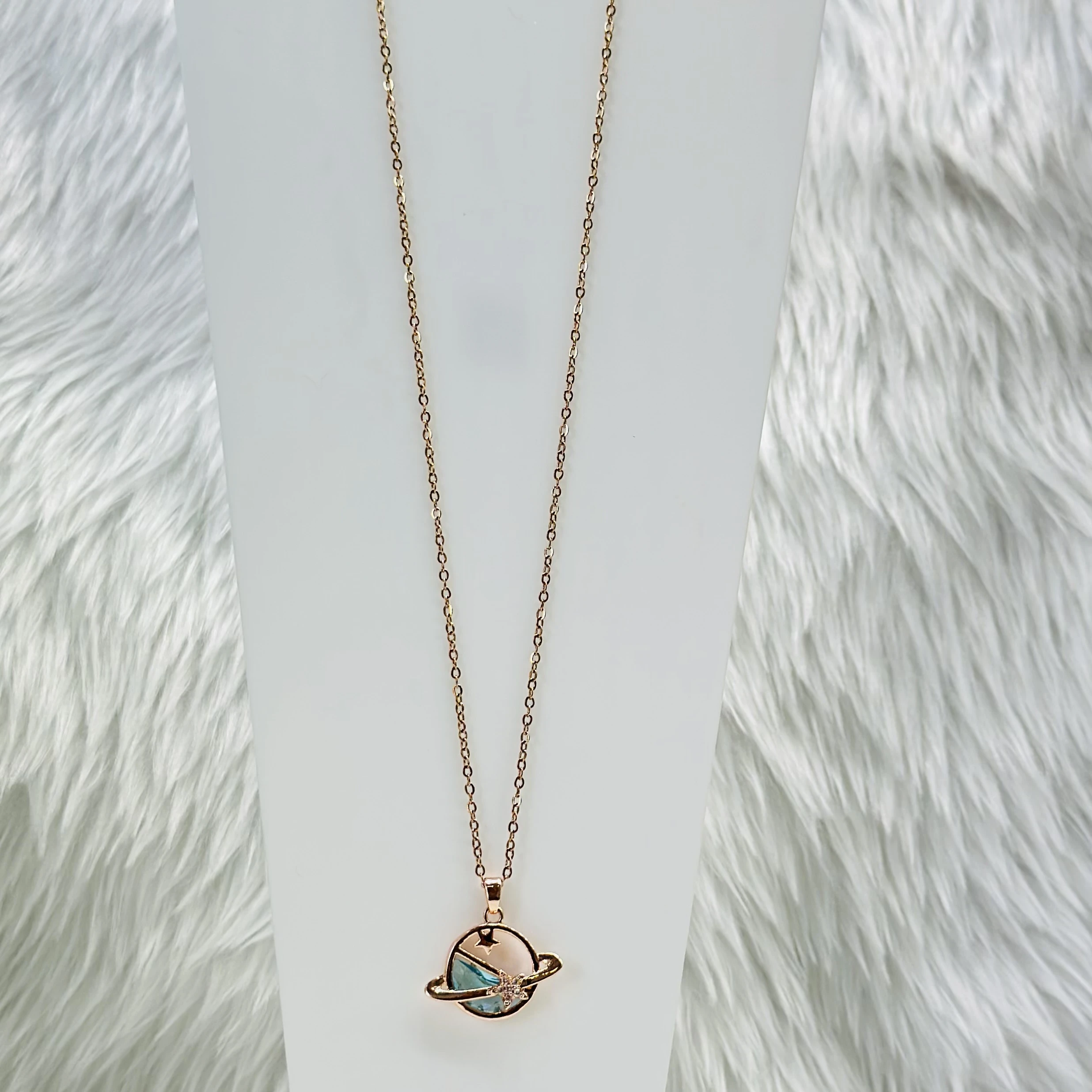 Rose gold tone planet pendant