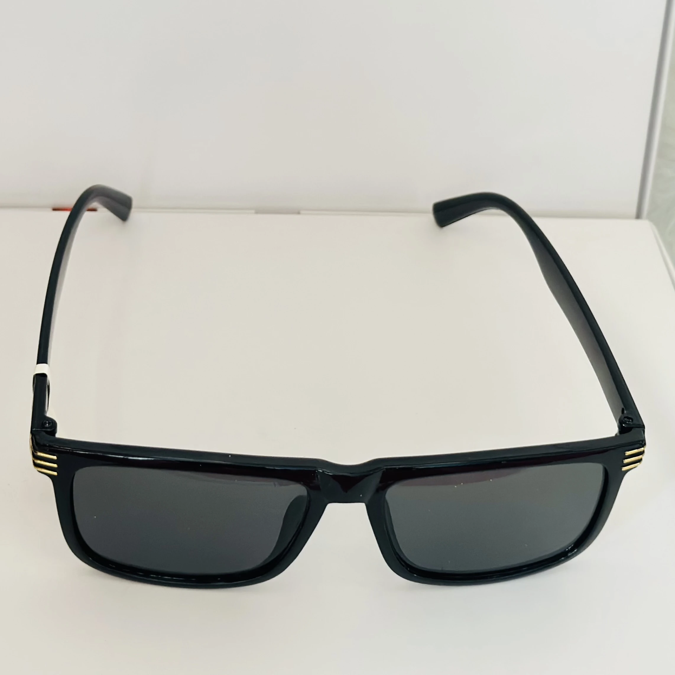 Saint Laurent SL 710 OPT eyeglasses with a black acetate frame and gold-toned details.