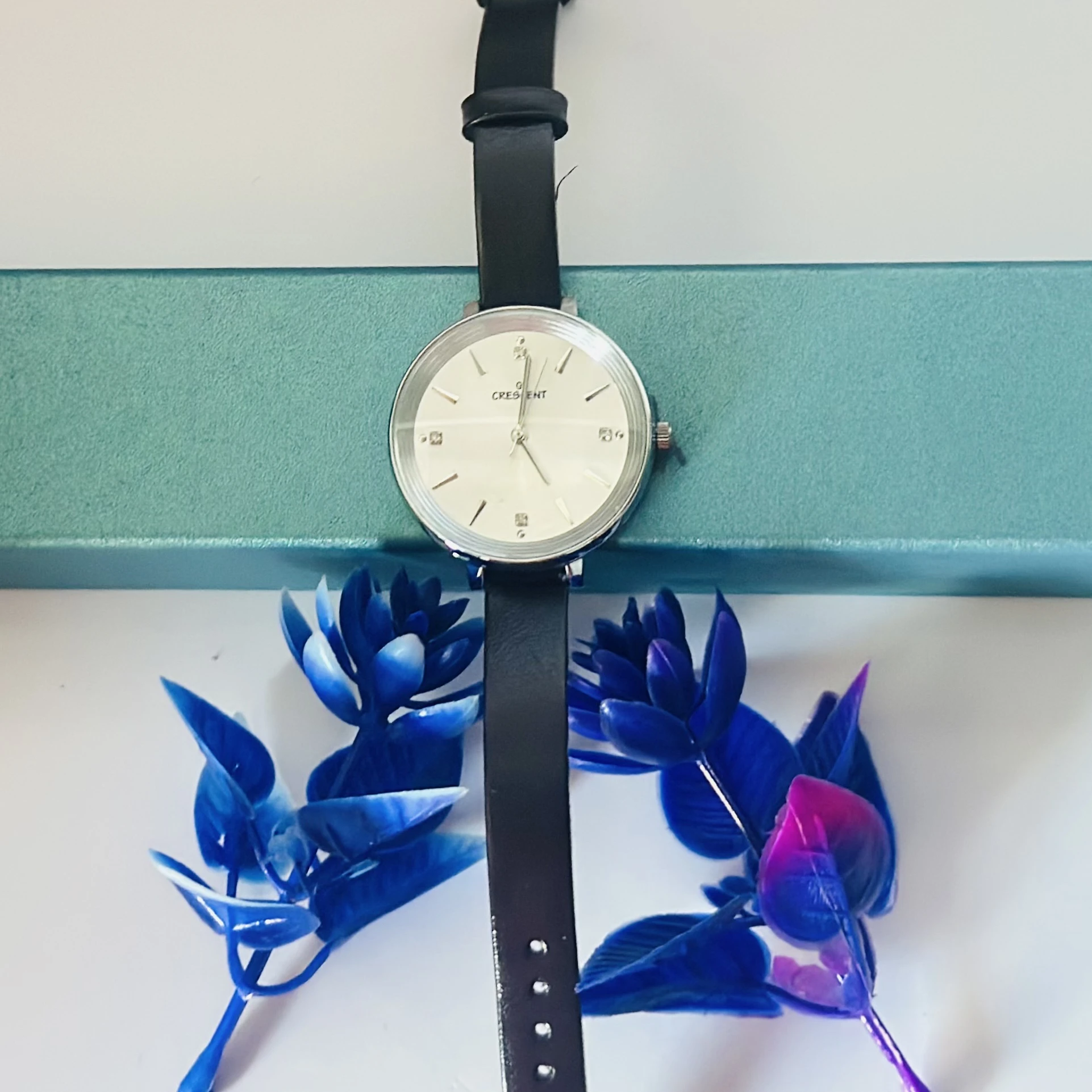 watch with a black leather band.