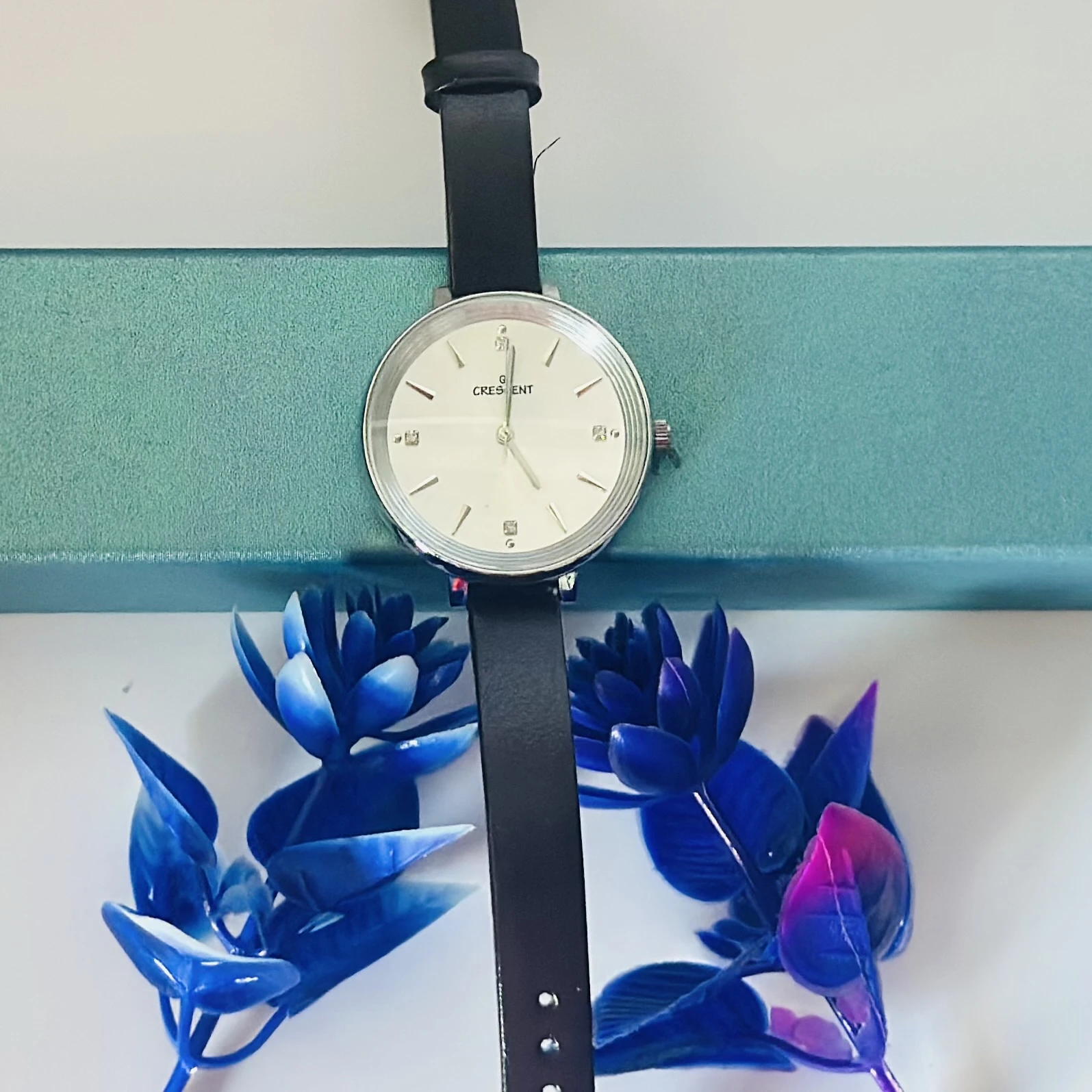 watch with a black leather band.