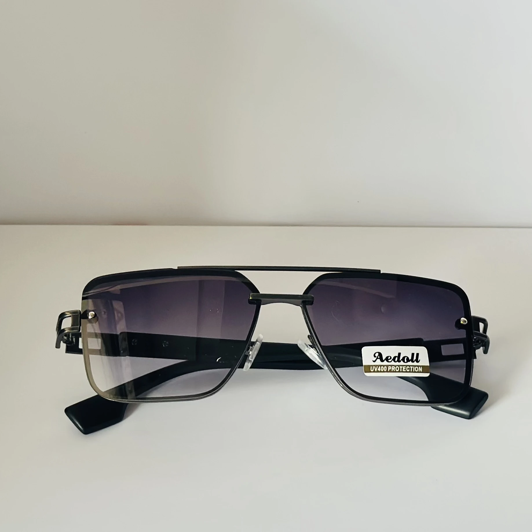 pair of Aedoll Goggle sunglasses with a gold metal frame and pink gradient lenses.