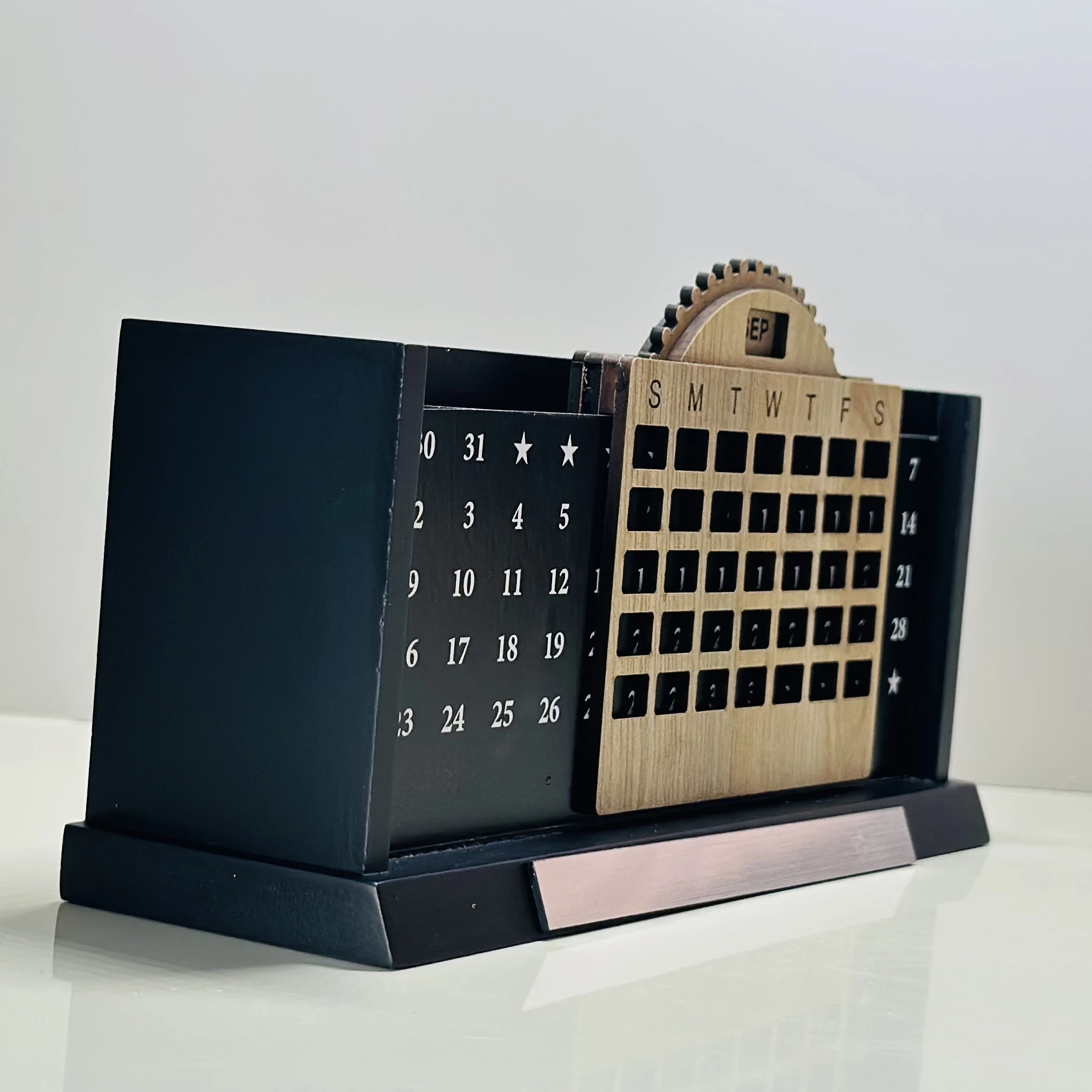 Wooden desk organizer that includes a perpetual calendar and a pen stand.
