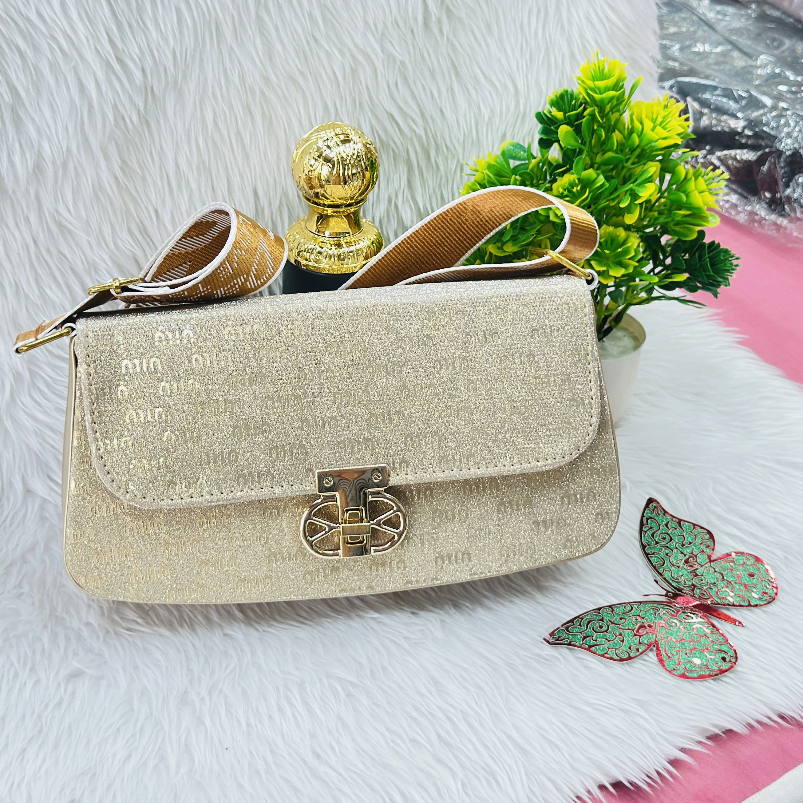 Gold colored, glittery structured handbag