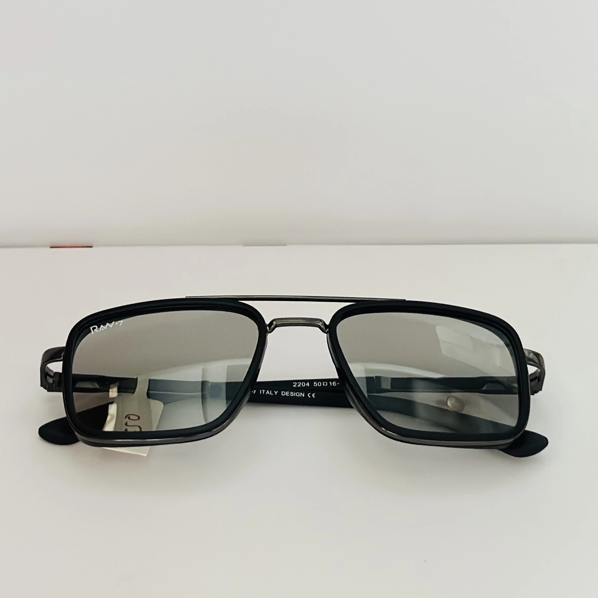 RAW-7 aviator sunglasses with a black frame and silver lenses.