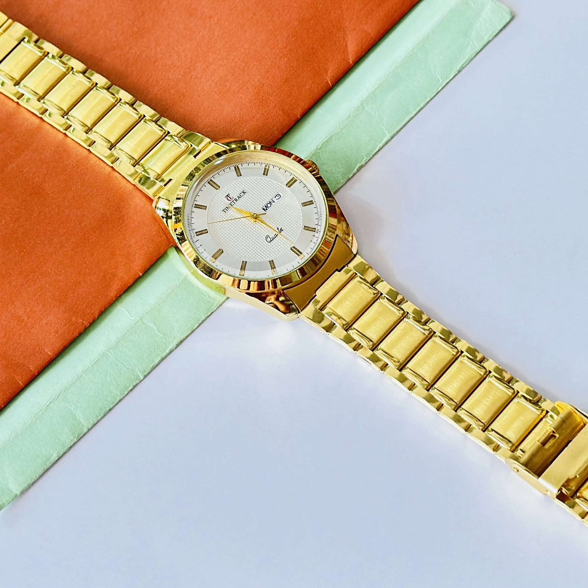 Gold coloured analogue watch