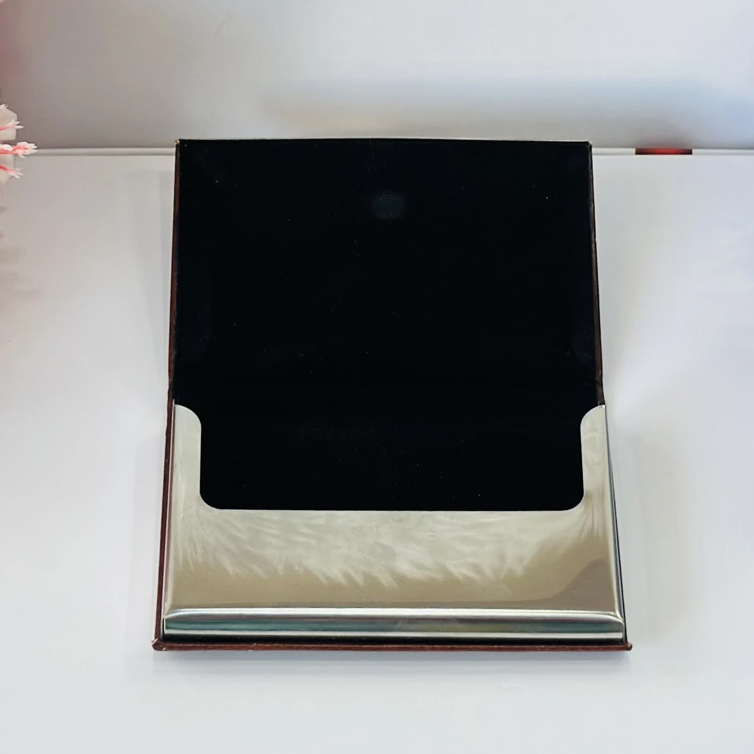 business card holder or card case, likely made of PU leather and stainless steel.