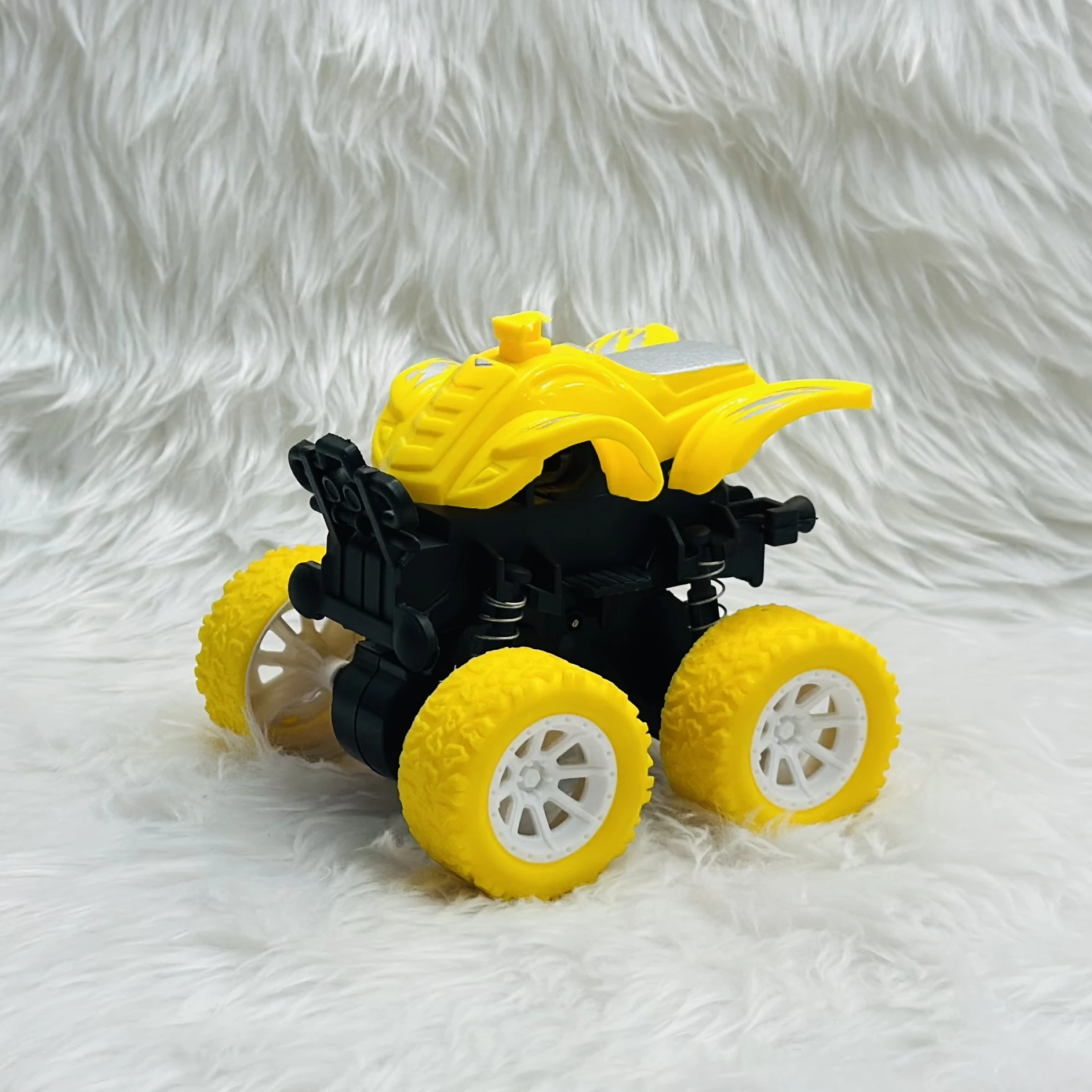 yellow friction-powered monster truck toy.