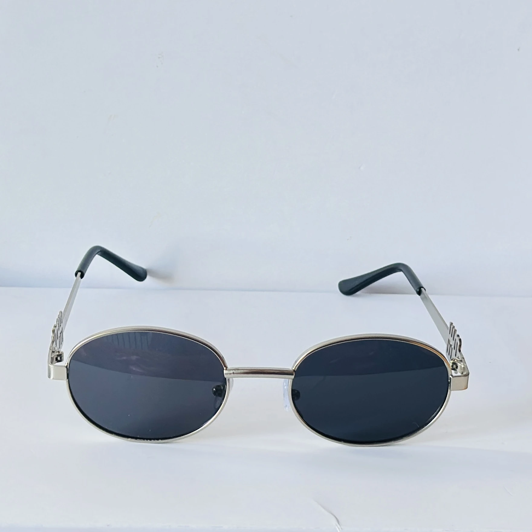Glasses are a pair oval-framed sunglasses