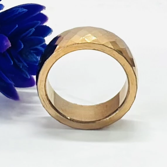 An 18K gold-plated titanium or tungsten carbide faceted band ring.