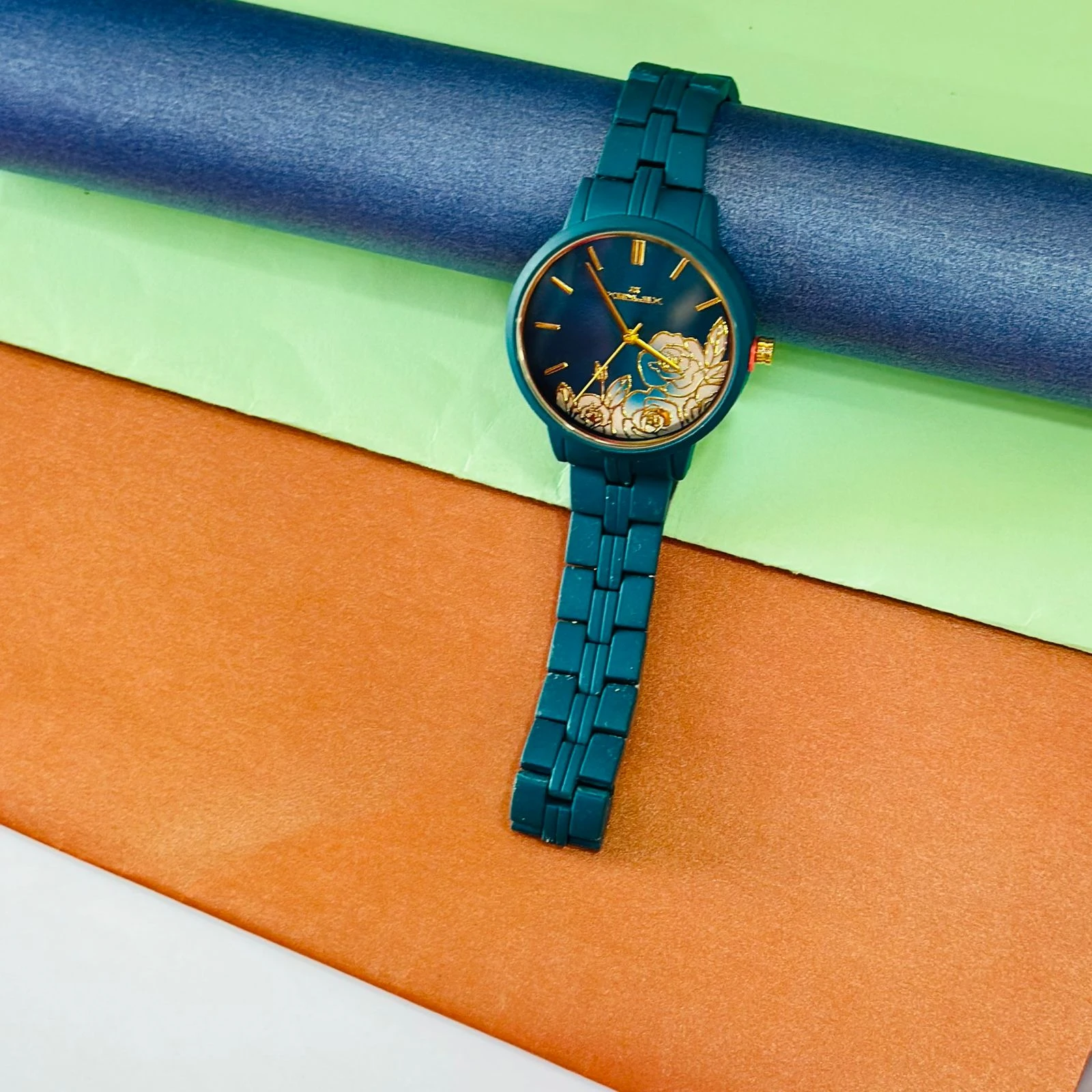 TEAL BY CHUMBAK Tulip Garden Quilted Analog Watch for Women in a teal blue hue.