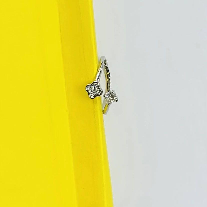 Silver bypass ring featuring lab-grown diamond floral clusters.