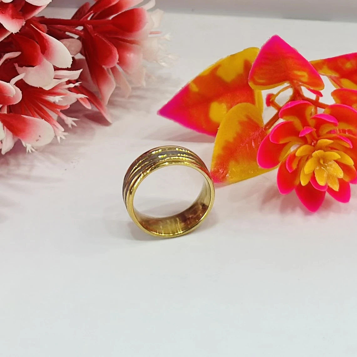 Gold and silver-toned stainless steel dual-edge wedding band with a brushed finish
