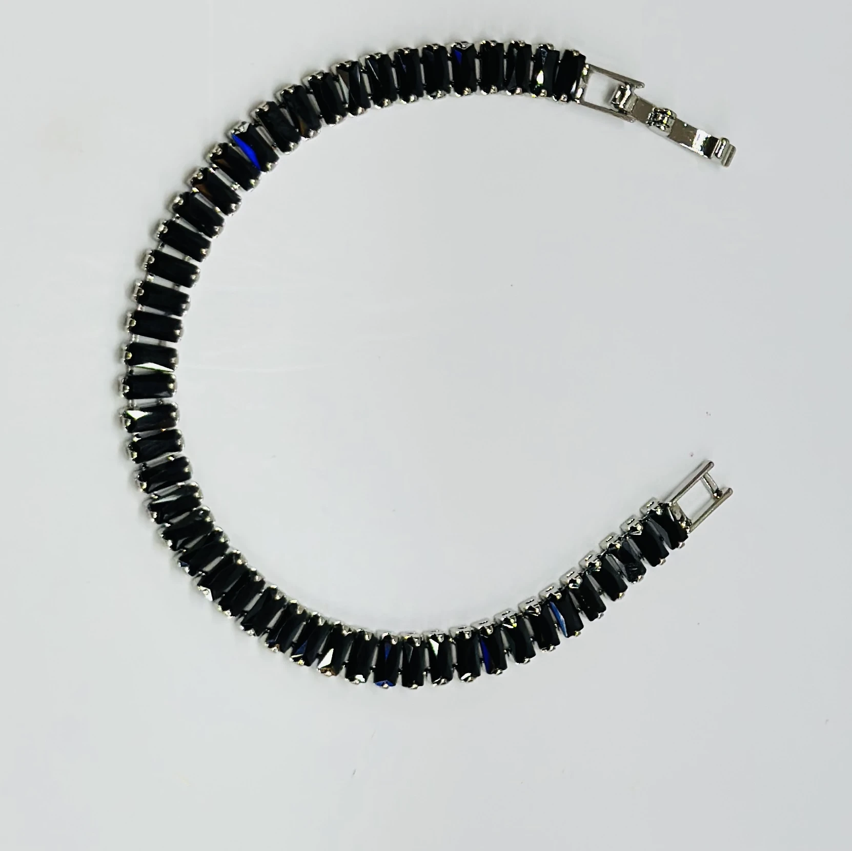 Gold plated black baguette tennis bracelet with artificial stones.