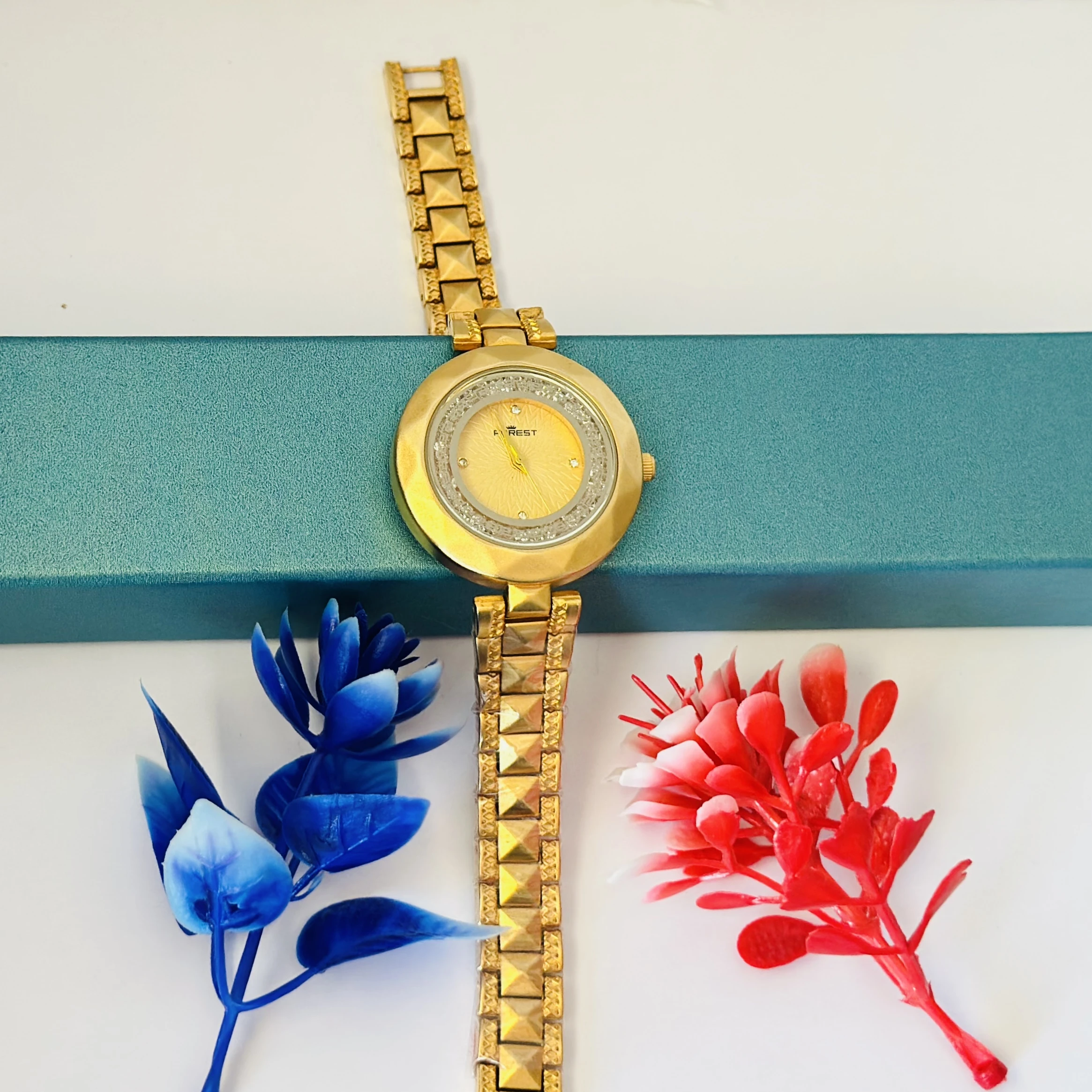 analog watch for women with a golden dial and band.