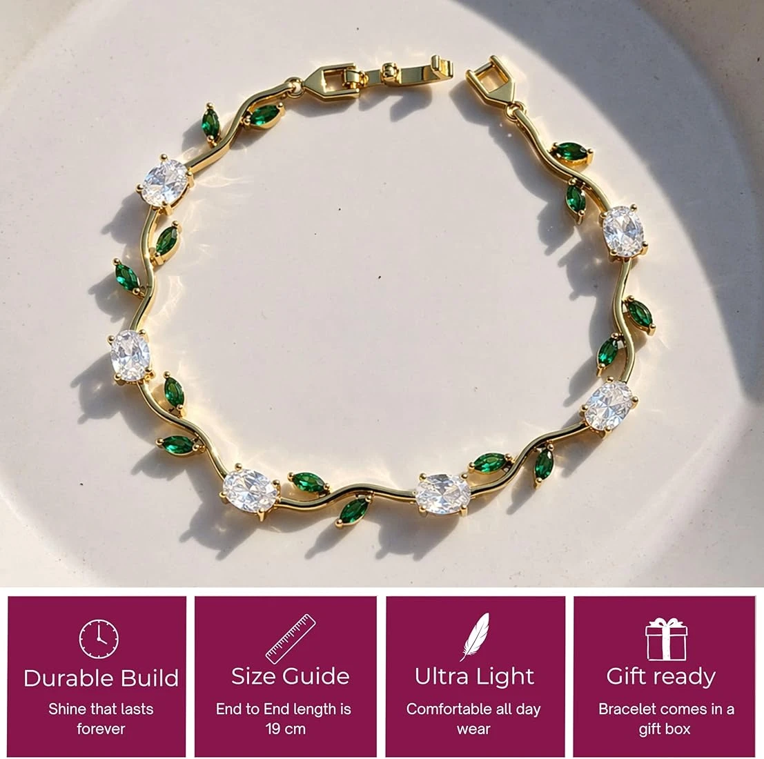 gold plated tulip bracelet featuring white oval crystals and green marquise leaf accents