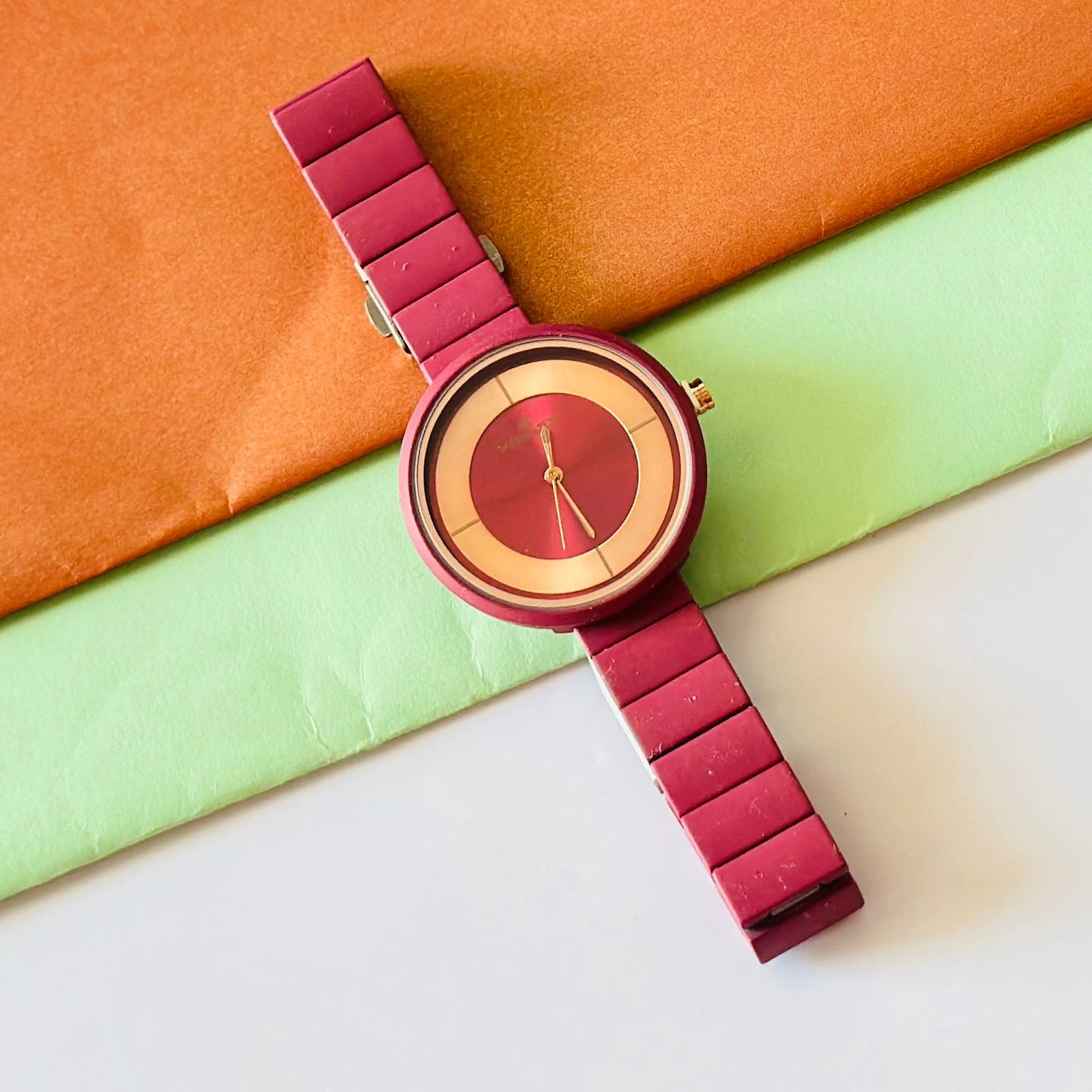 burgundy or red analogue watch for women, possibly from brands like Fastrack or Watchstar