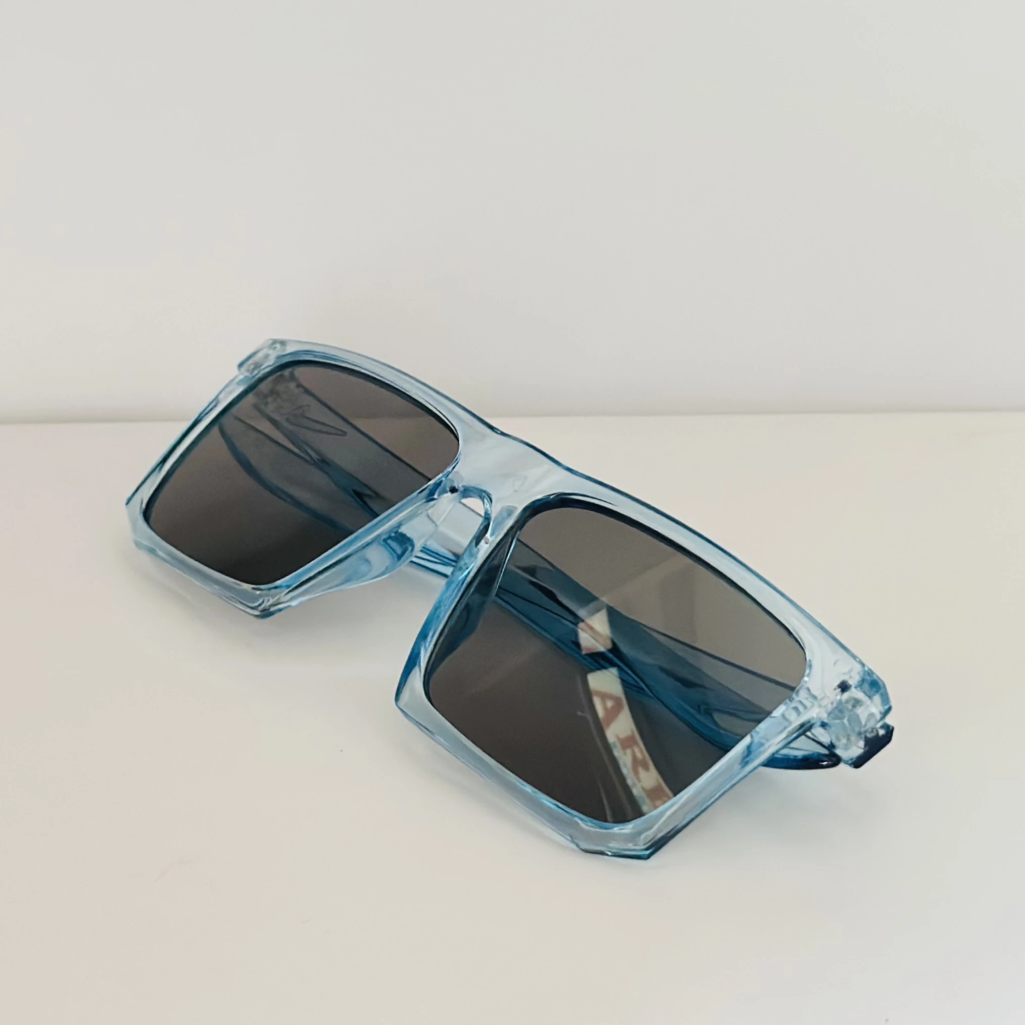 Voyage polarized sunglasses with a blue frame and black lenses.