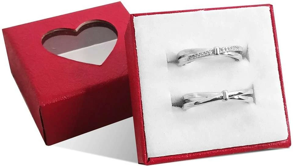 set of silver-plated, adjustable couple rings featuring a double bowknot design, with one ring studded with cubic zirconia stones.