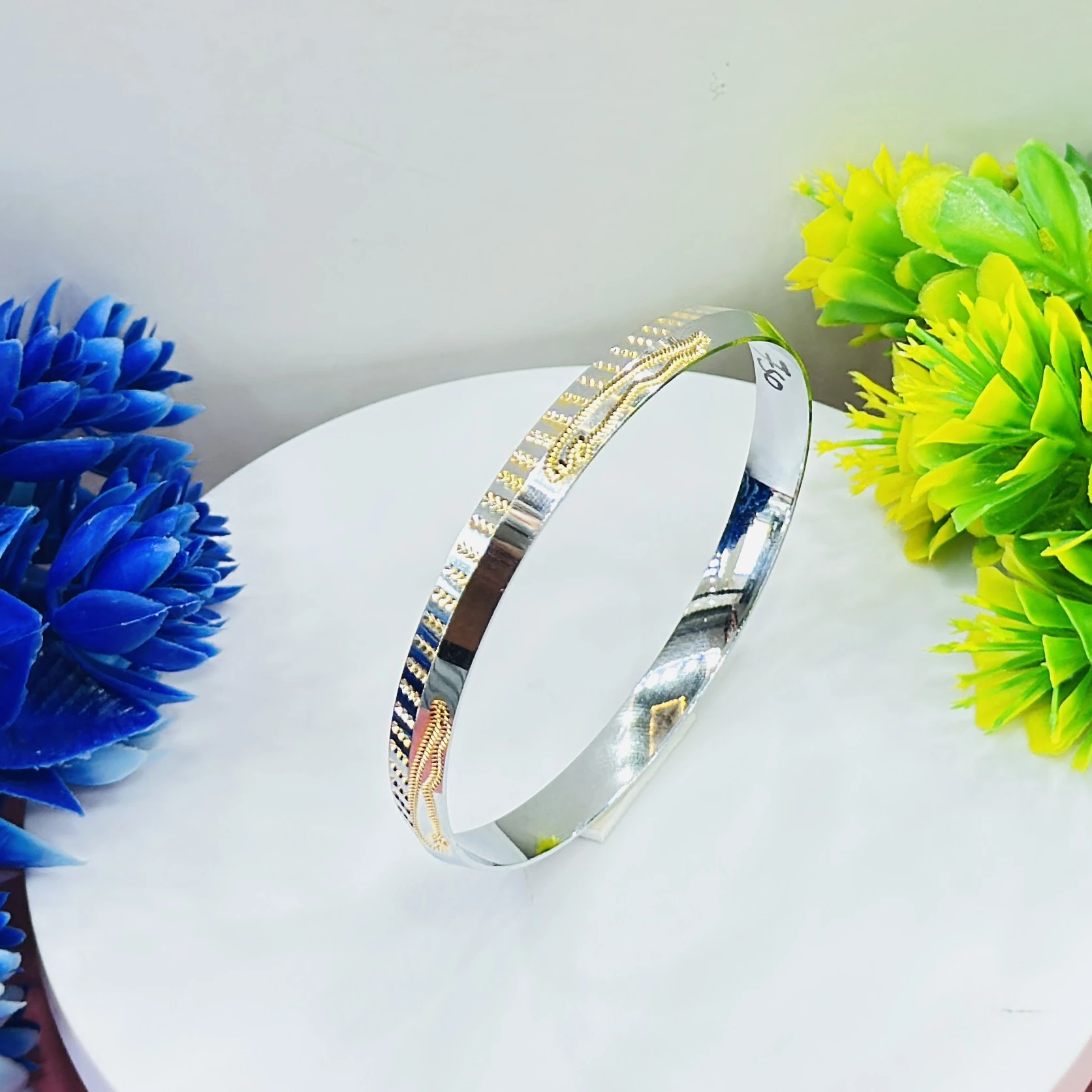 silver dual-tone men's kada with gold plating, featuring a polished finish.