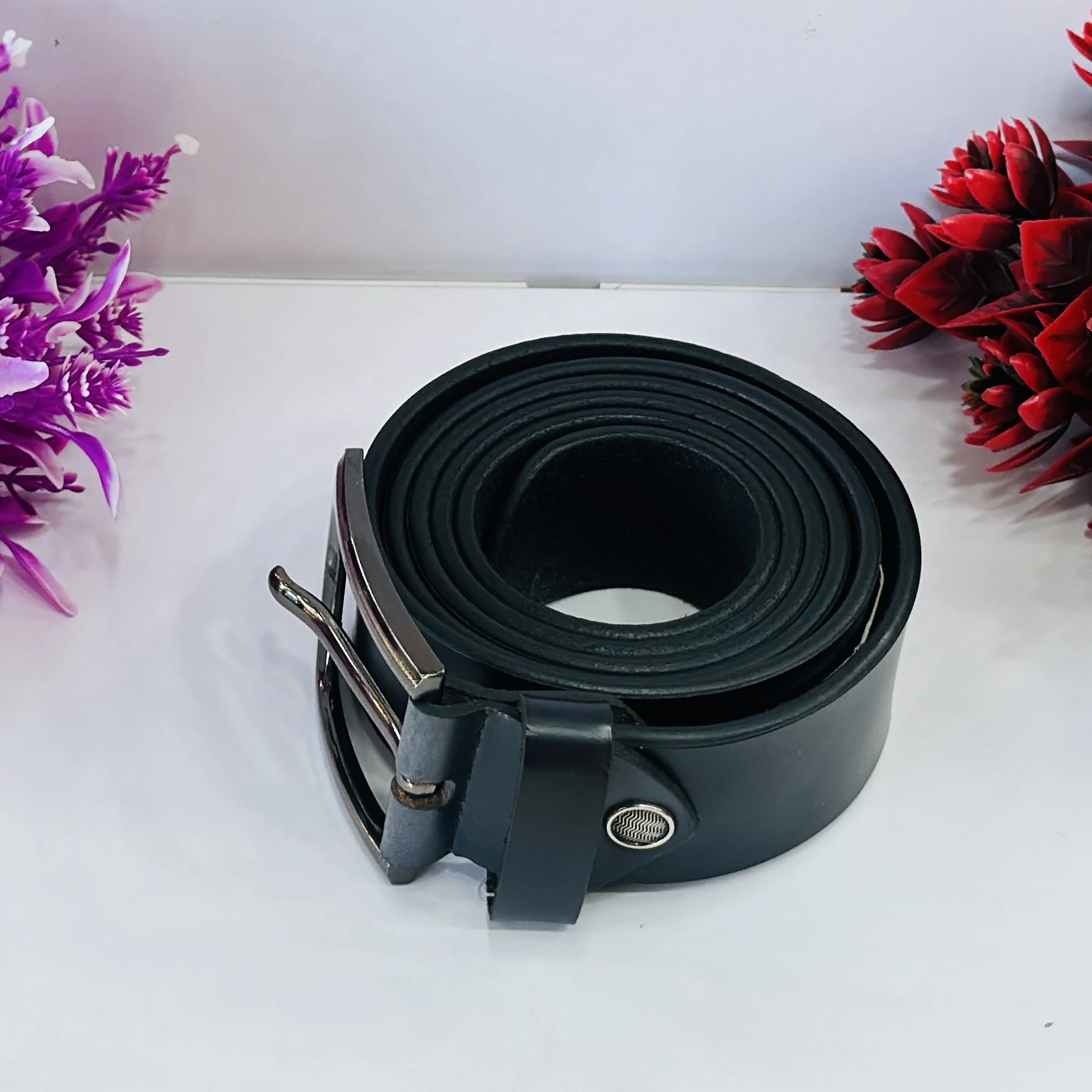 Black leather belt with a metal buckle.