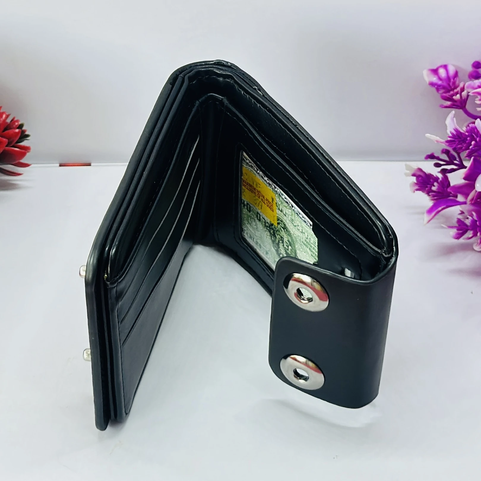 Black bi-fold men's wallet with a snap closure, branded as "Balisi".