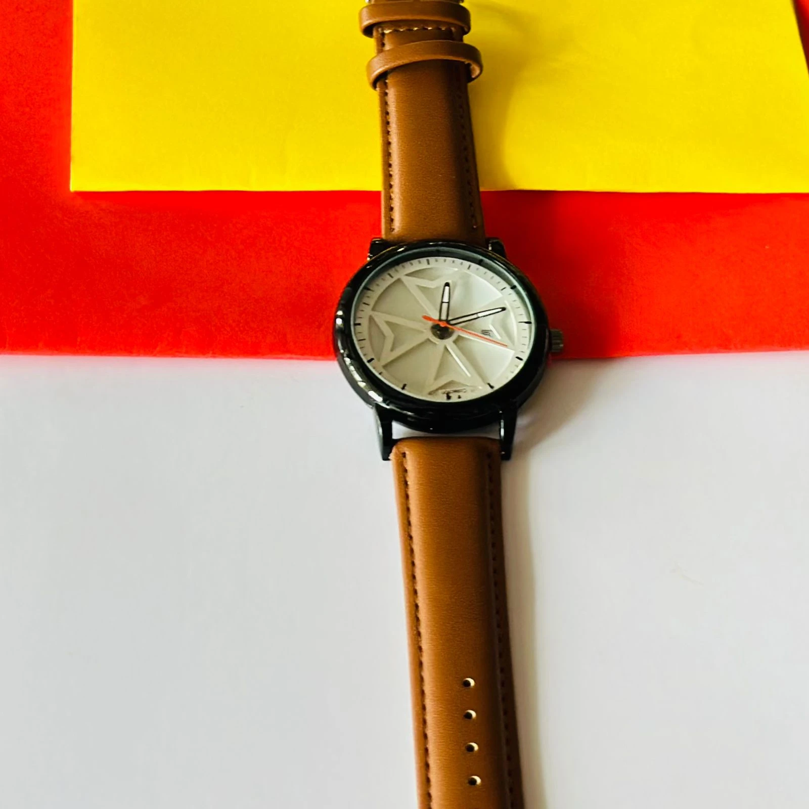 Round analog watch with a brown leather strap
