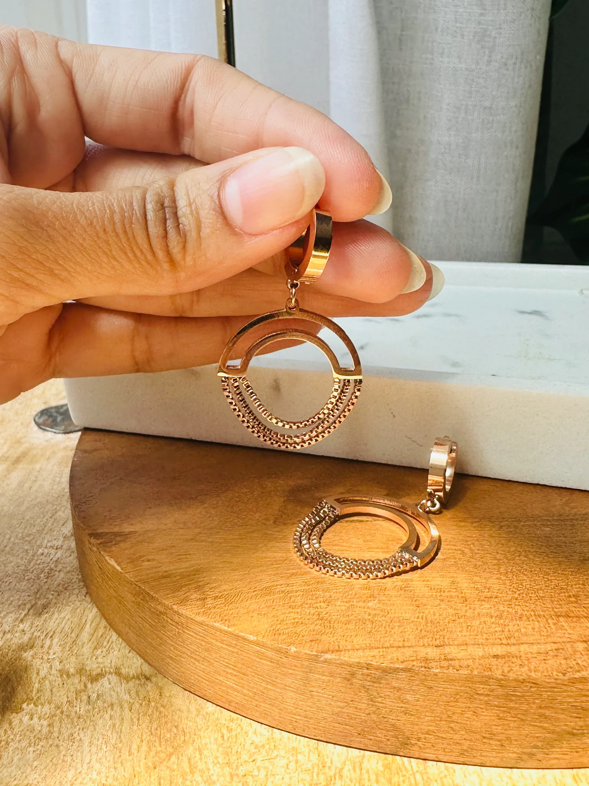 Gold plated chained circle drop earrings.