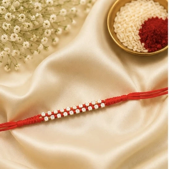 rakhi features a vibrant red multistrand design