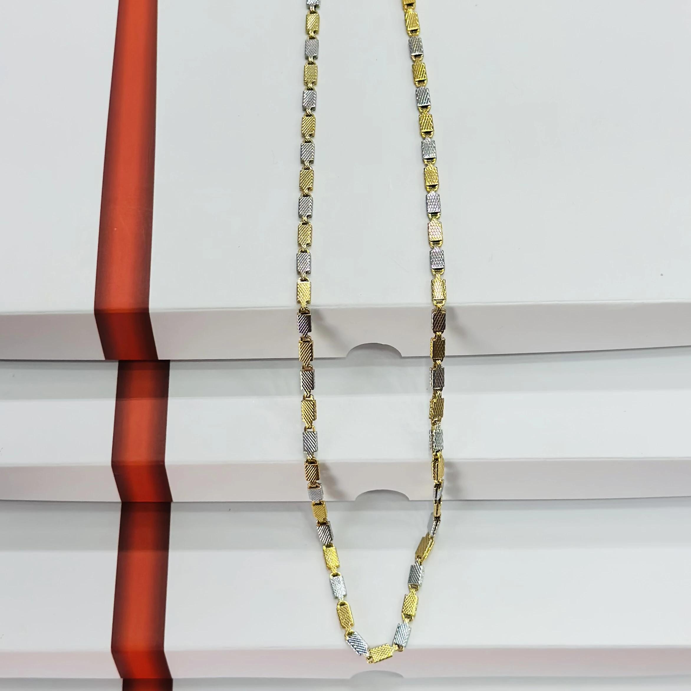 Two tone silver and golden-colored stainless steel chain