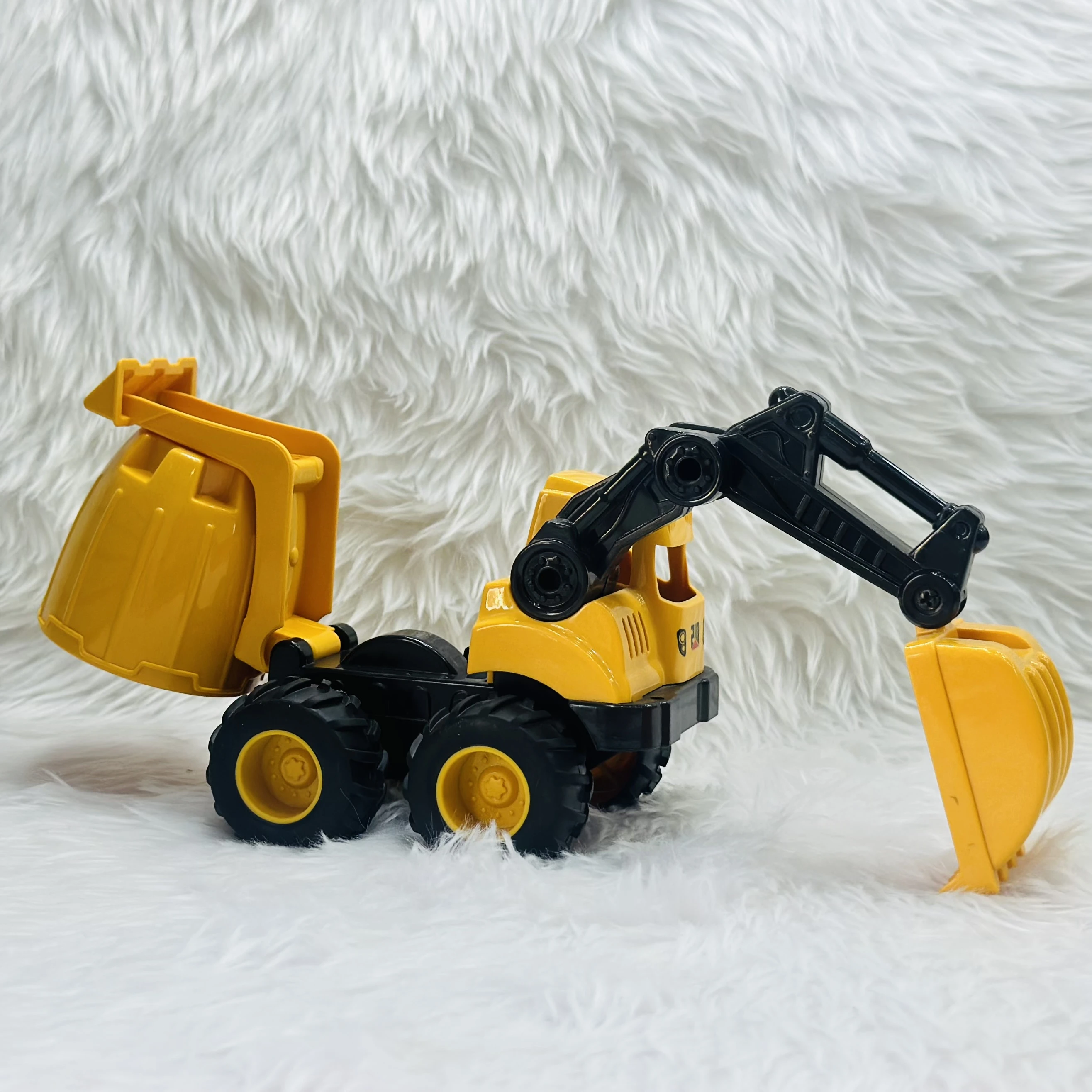 Cement mixer with an attached excavator arm.