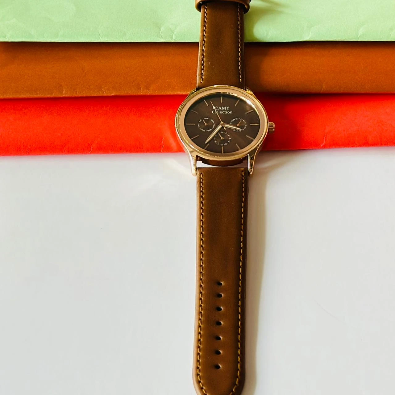 Round analog watch with a brown leather strap