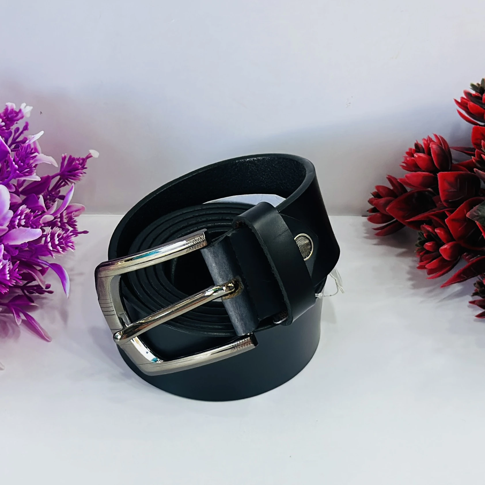 Black leather belt with a metal buckle.