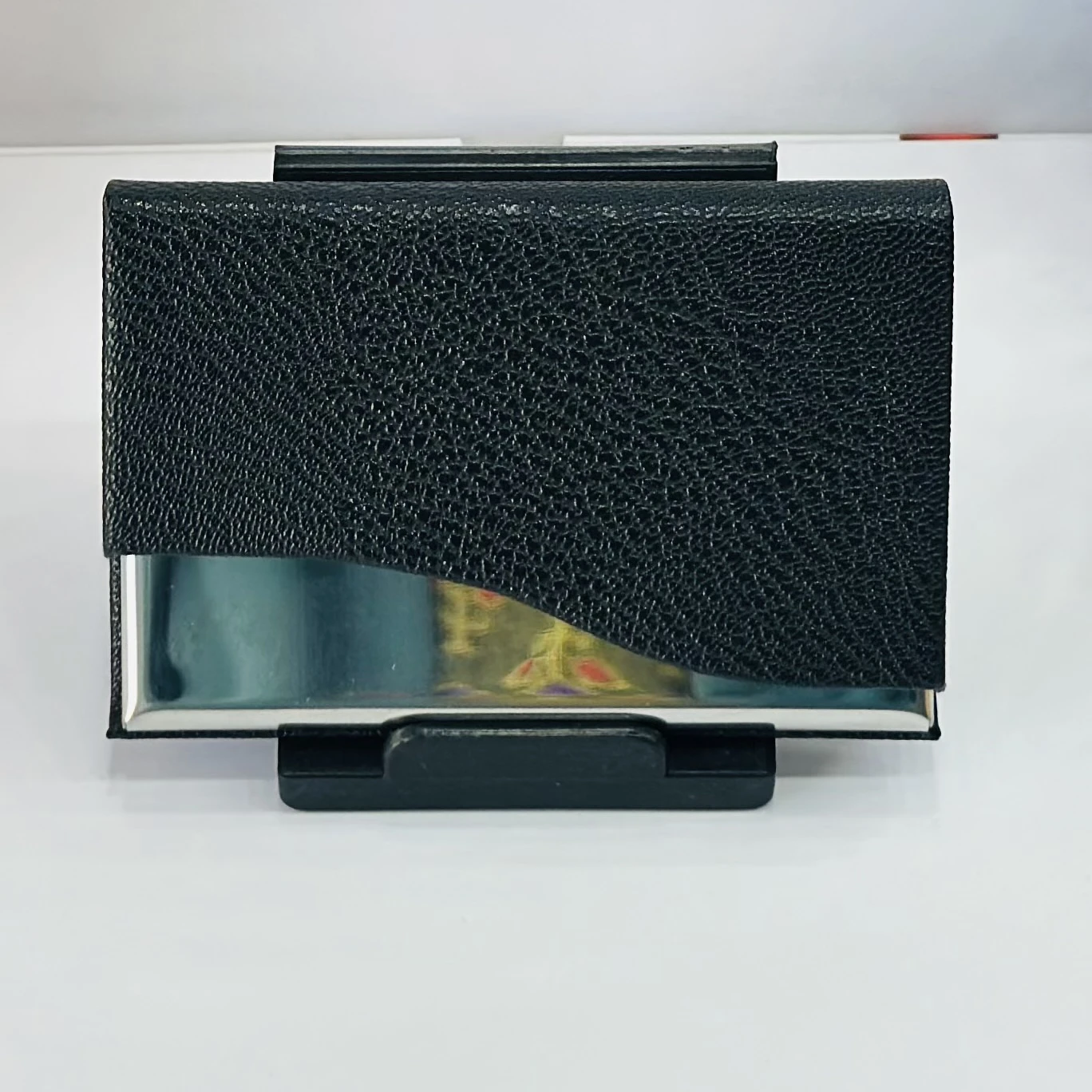 black faux leather and metal business card holder.