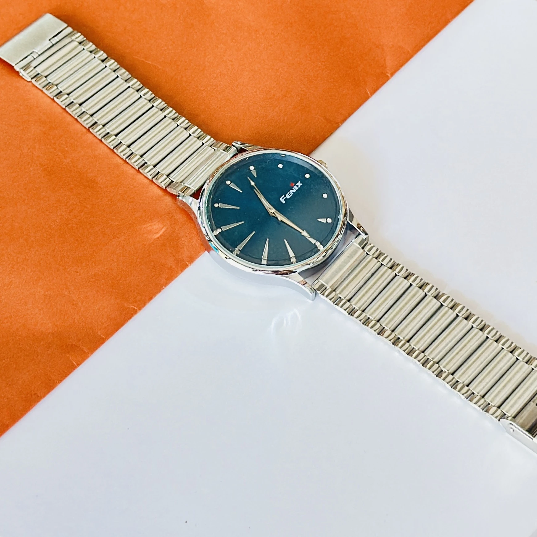 Blue dial with stick indices and a silver-toned stainless steel strap