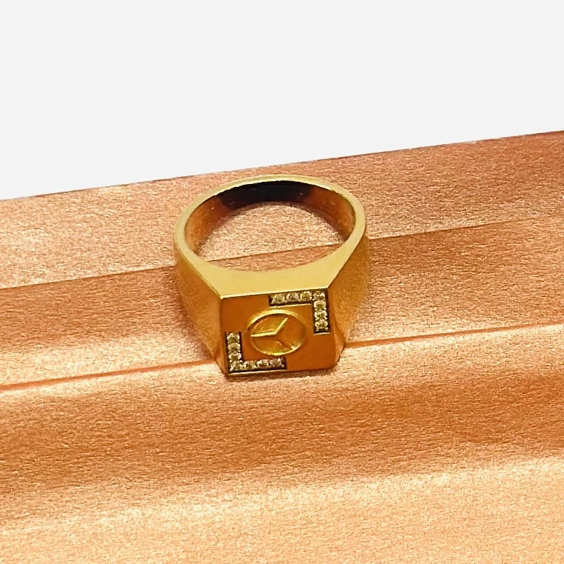 Gold plated men's finger ring with a Mercedes-Benz logo and diamond accents
