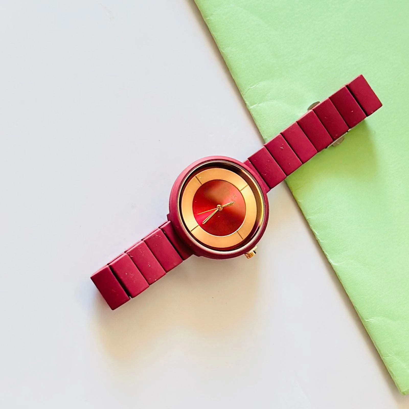 burgundy or red analogue watch for women, possibly from brands like Fastrack or Watchstar
