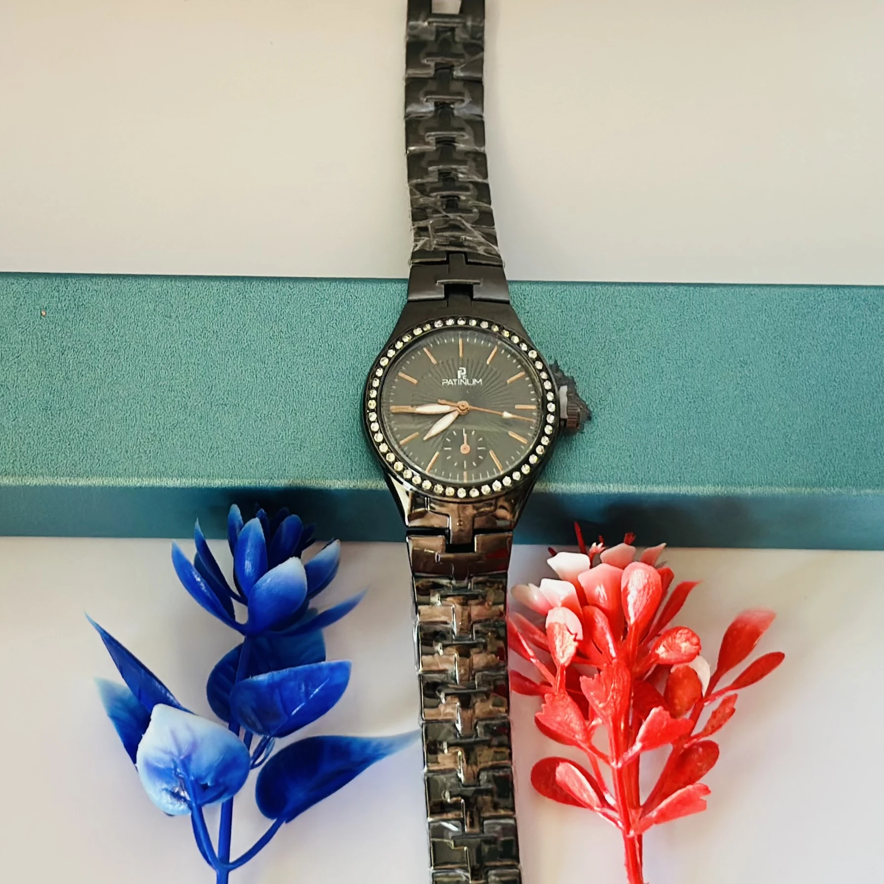 ceramic watch with a black dial and diamond-set bezel.