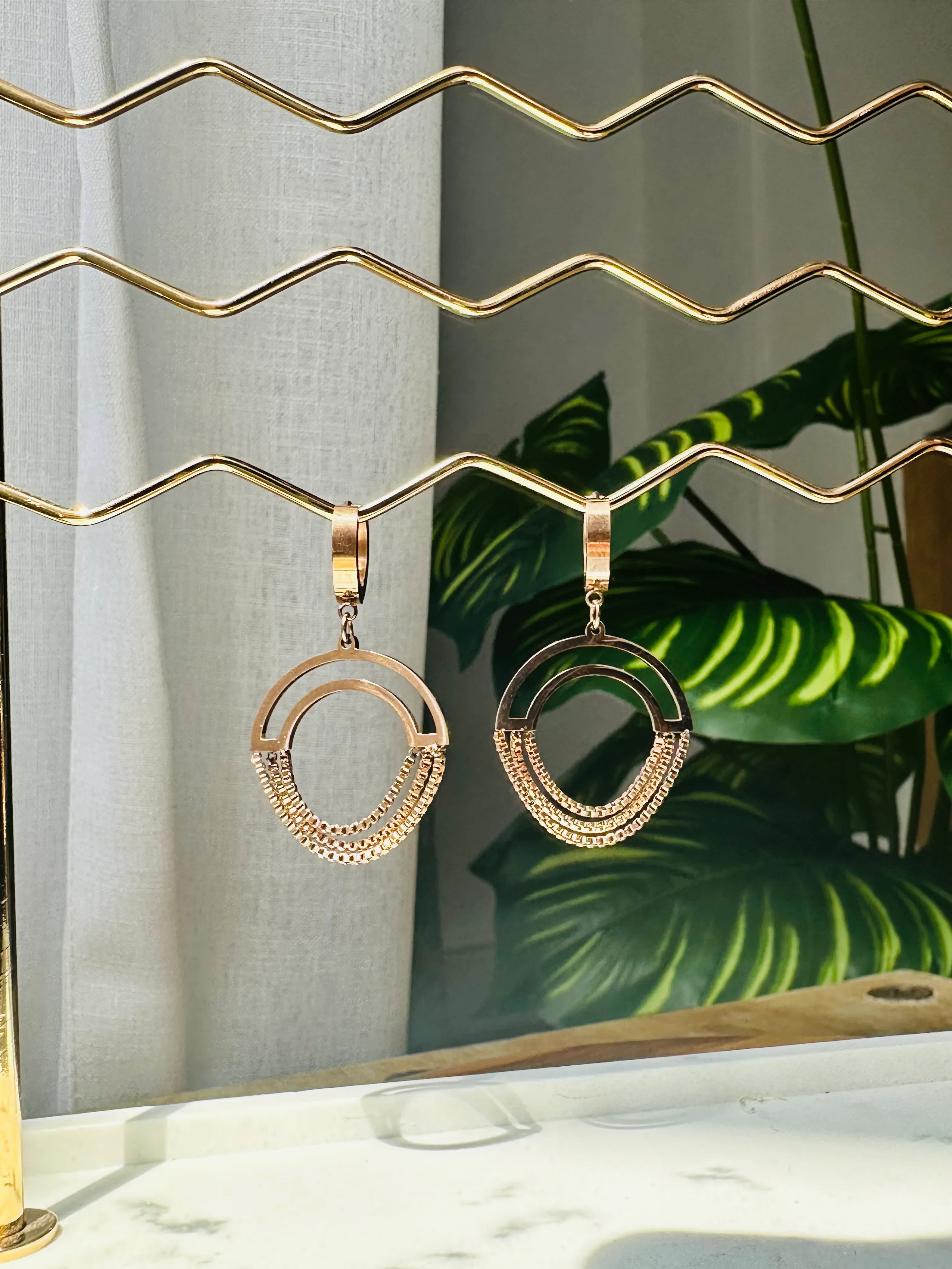 Gold plated chained circle drop earrings.