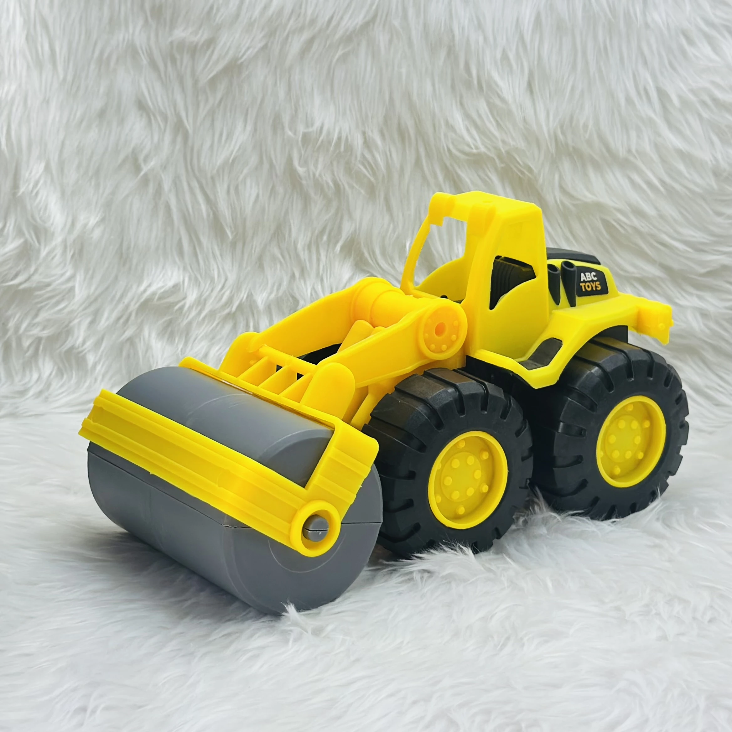 Yellow ABC Toys plastic road roller toy.