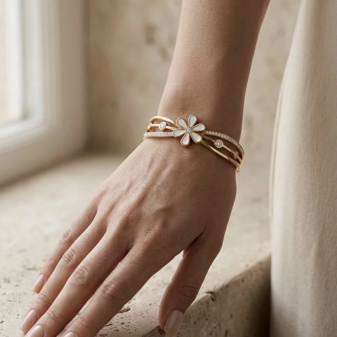Gold tone hinged bangle bracelet