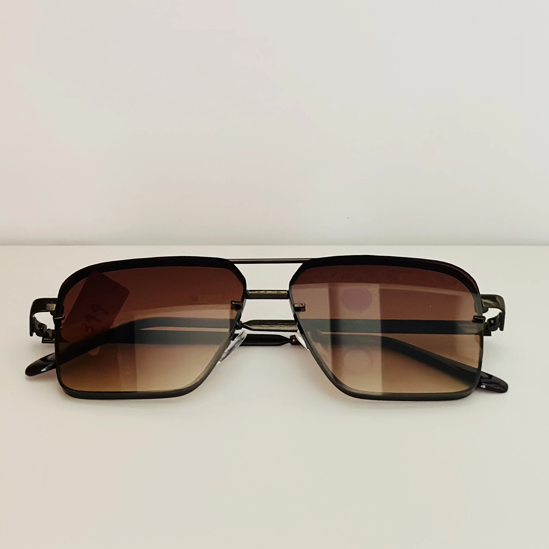 pair of square aviator gradient sunglasses with a brown metal frame.