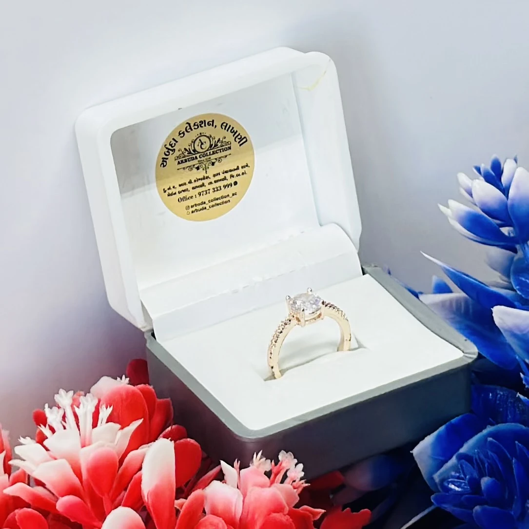 Gold toned ring with a large central clear stone