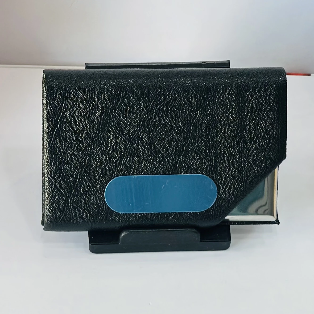 Black faux leather and metal business card holder.