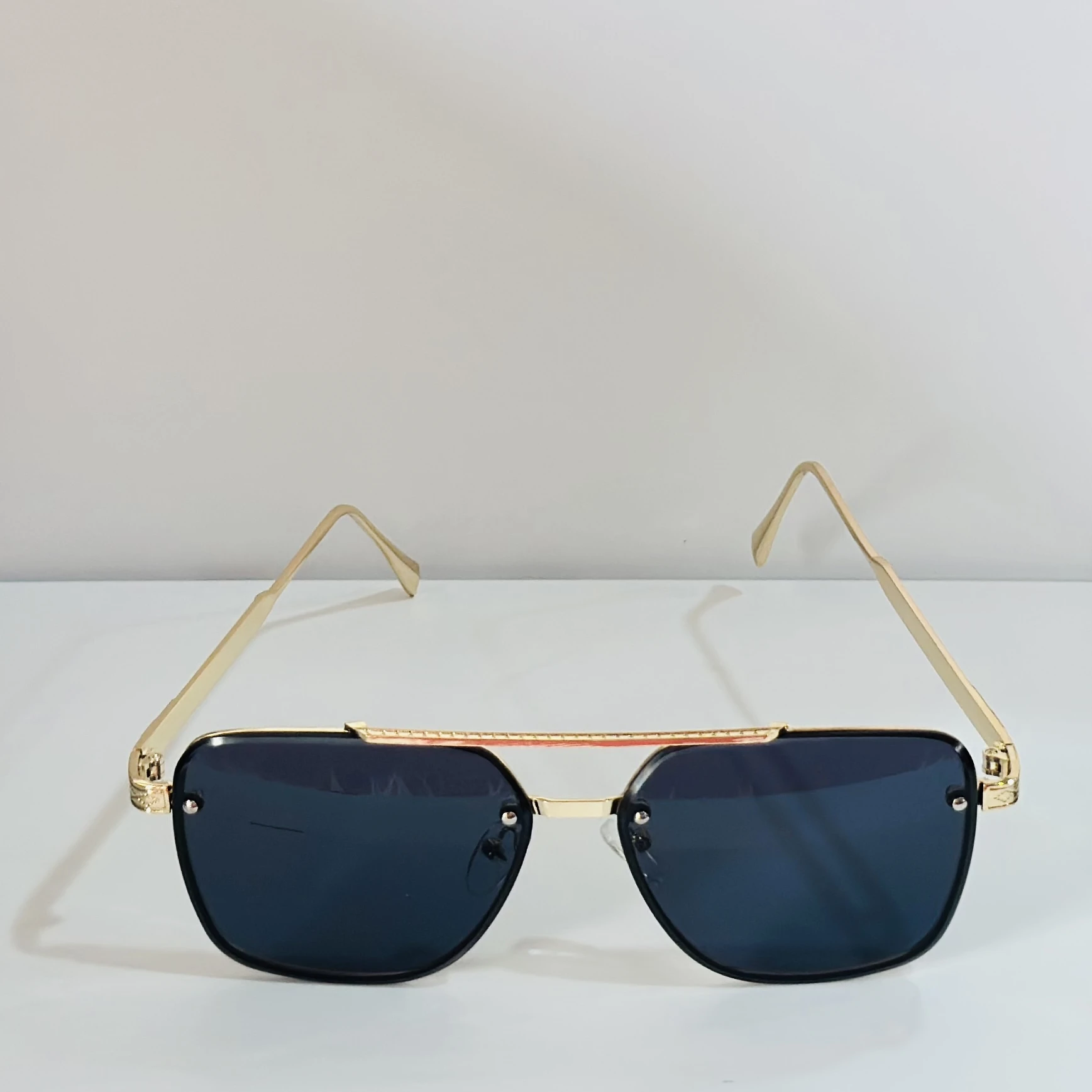 pair of Versace VE 2275 sunglasses with a gold metal frame and black/grey lenses.