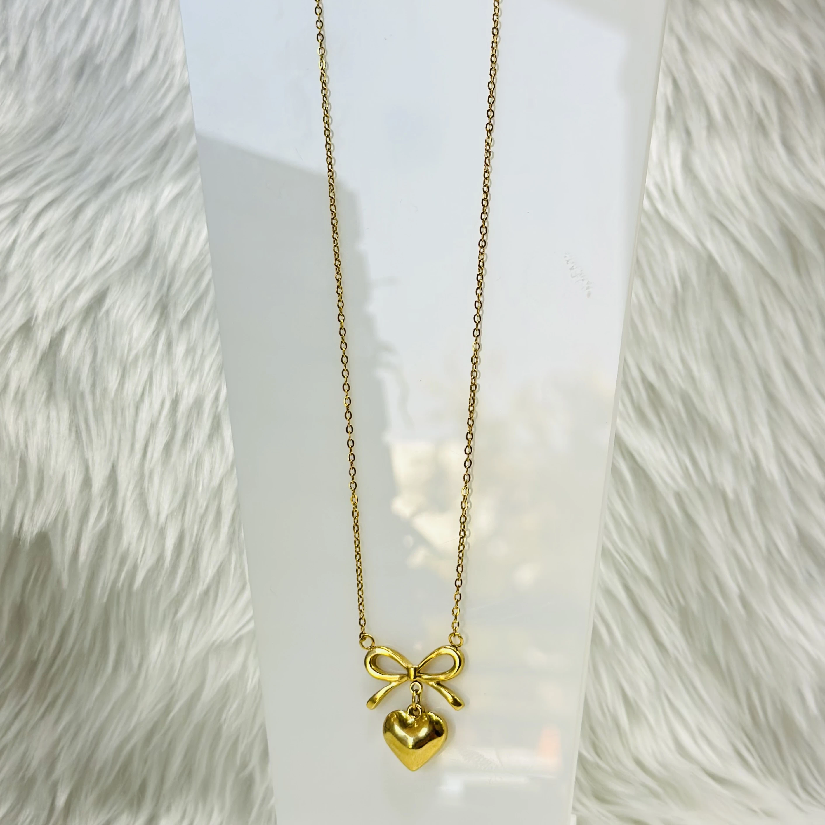Gold plated stainless steel anti-tarnish necklace with a bow and heart pendant