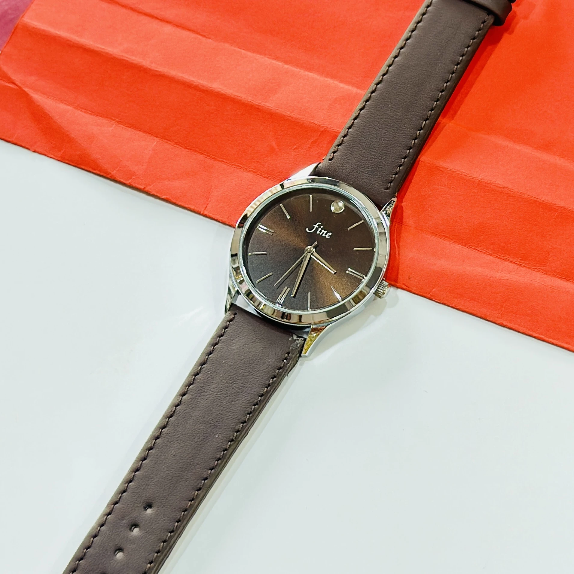 wristwatch with a brown leather band
