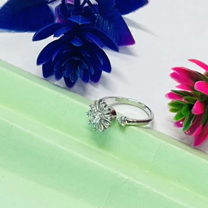Silver toe ring featuring a white zircon floral design.
