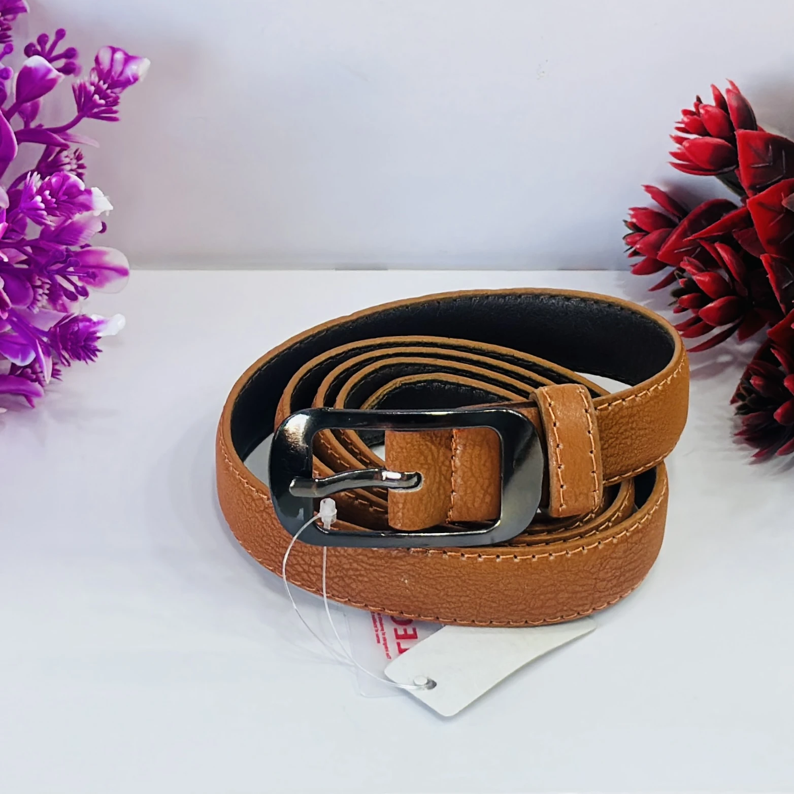 Tan casual leather belt with a needle pin buckle.