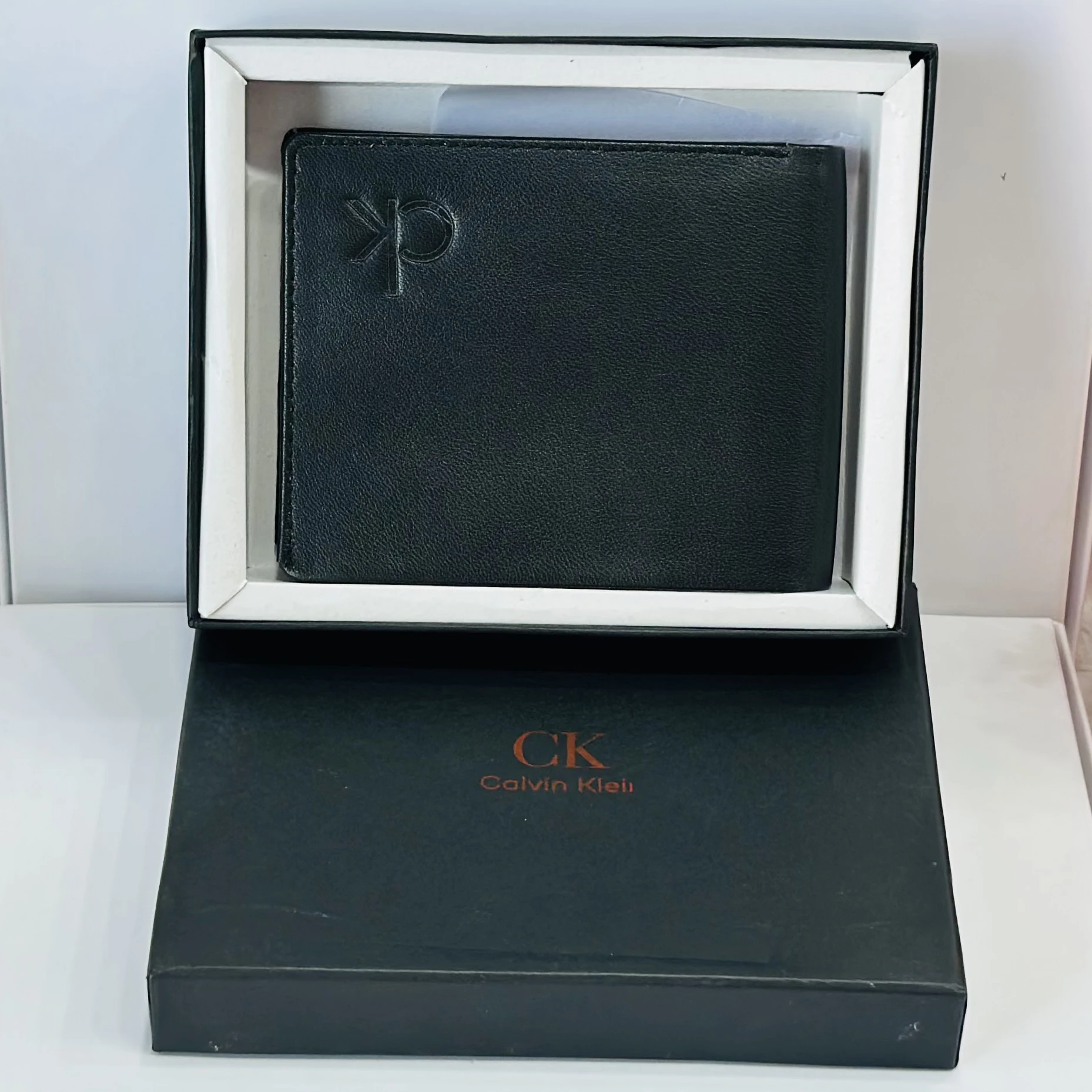 Calvin Klein men's black solid leather bi-fold wallet.